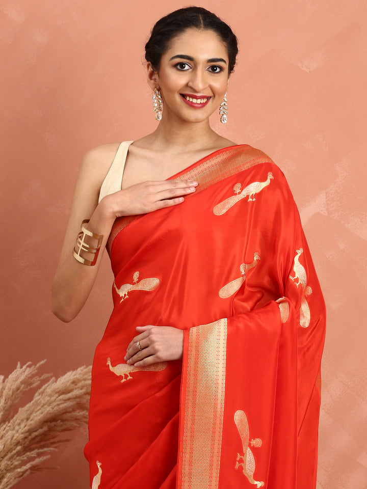 Red and gold silk saree with peacock booti pallu