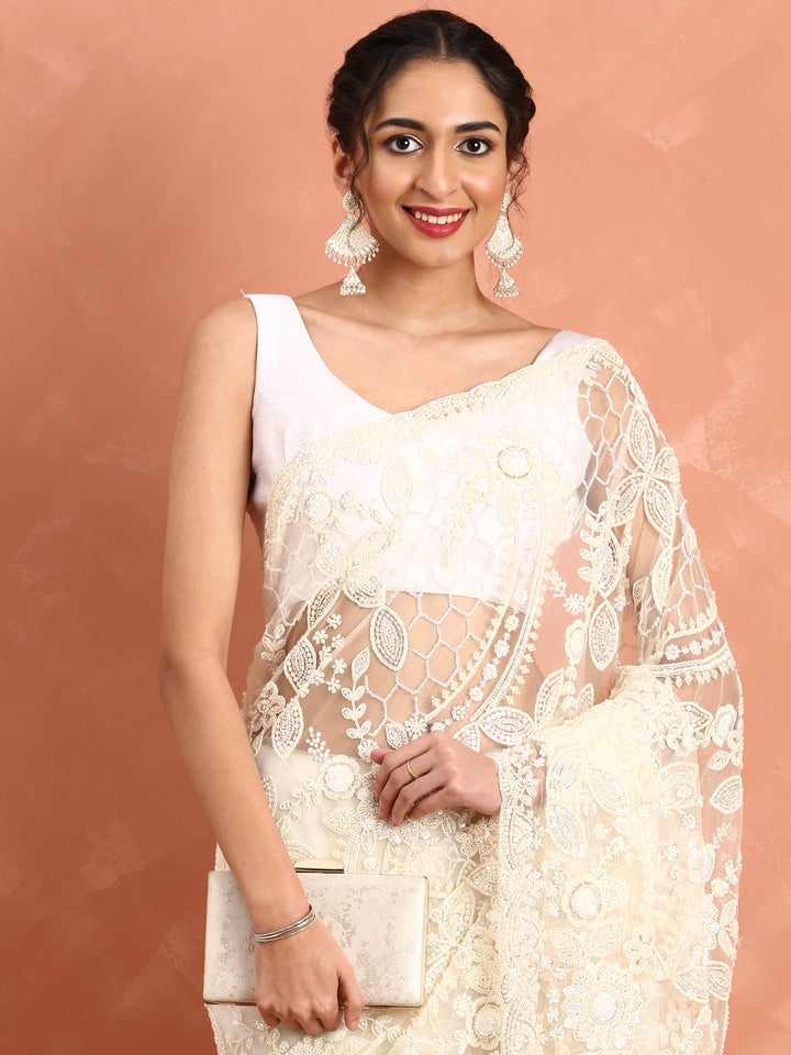 Cream net saree with pearl and sequins hand embroidery with scallop border