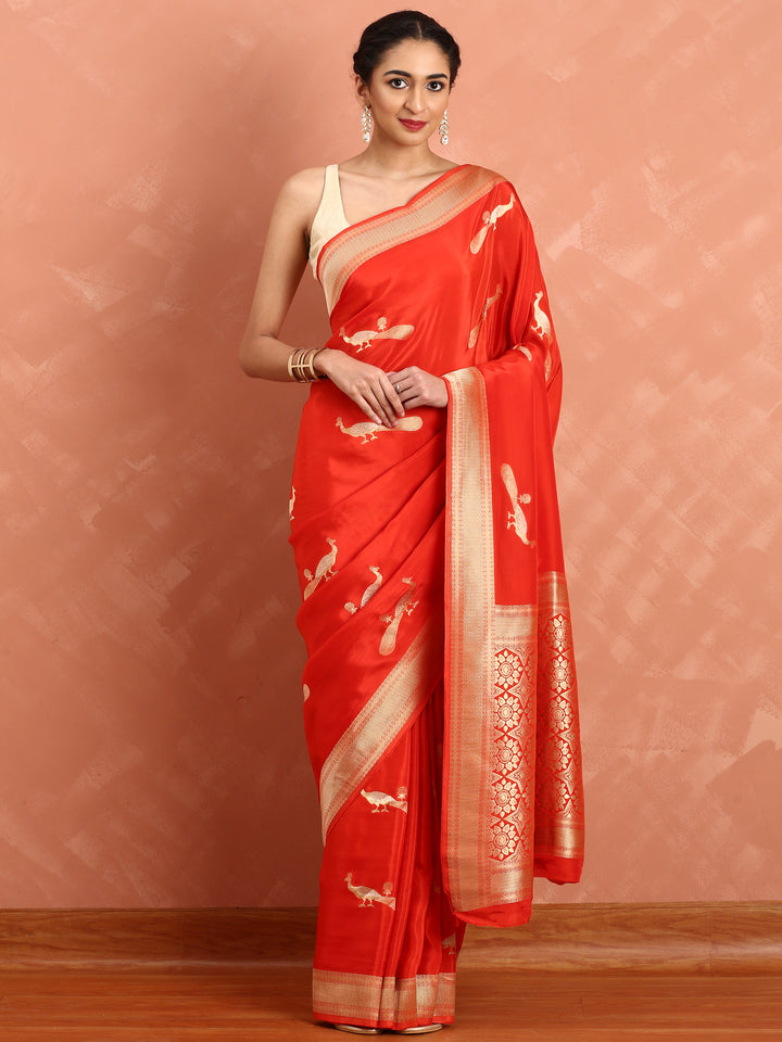 Red and gold silk saree with peacock booti pallu