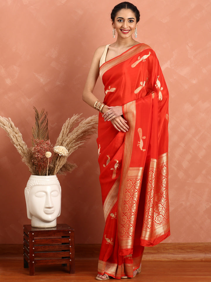 Red and gold silk saree with peacock booti pallu