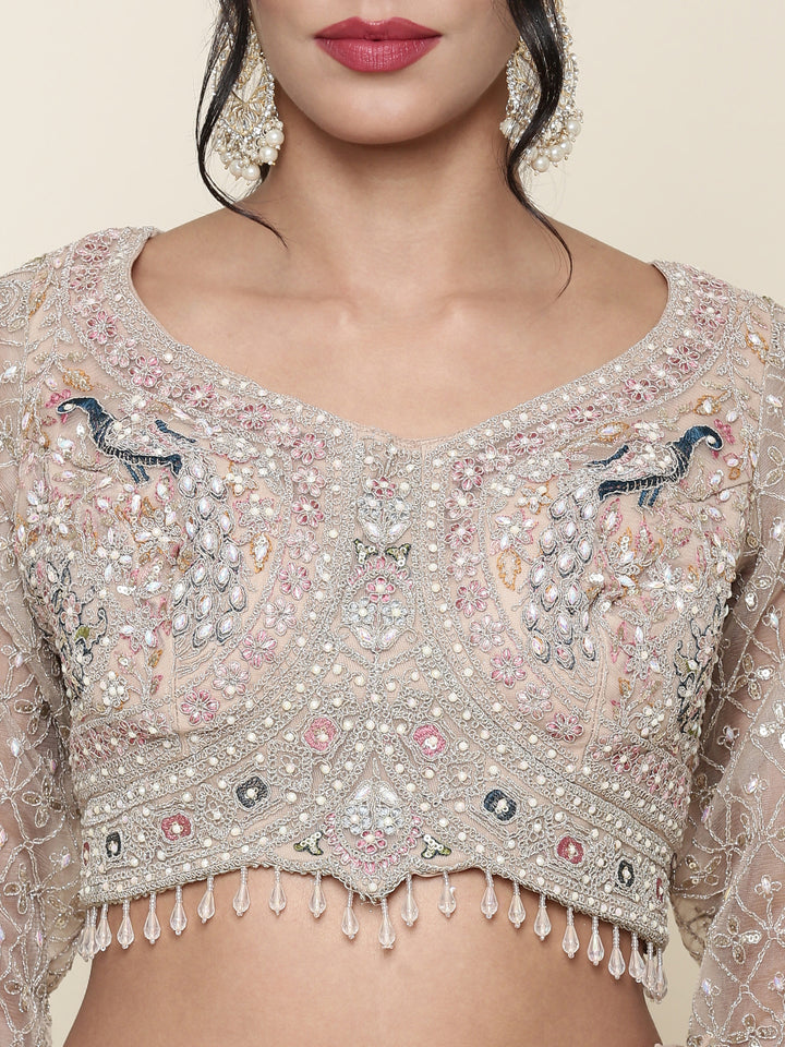 Beige net heavy embroidered three piece ghagra set