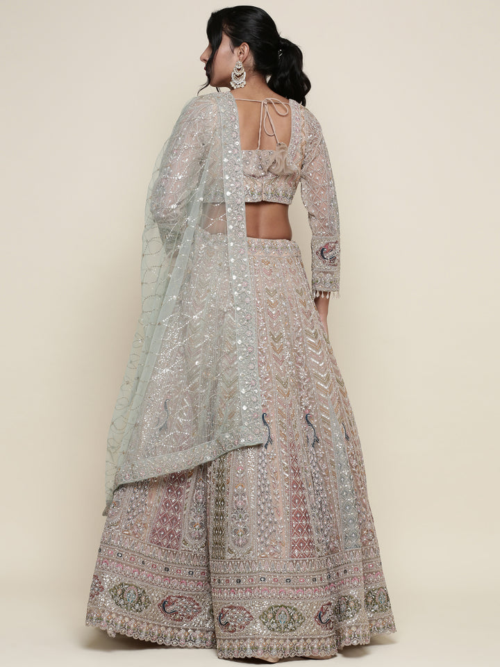 Beige net heavy embroidered three piece ghagra set