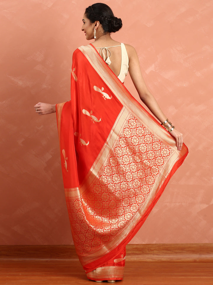 Red and gold silk saree with peacock booti pallu