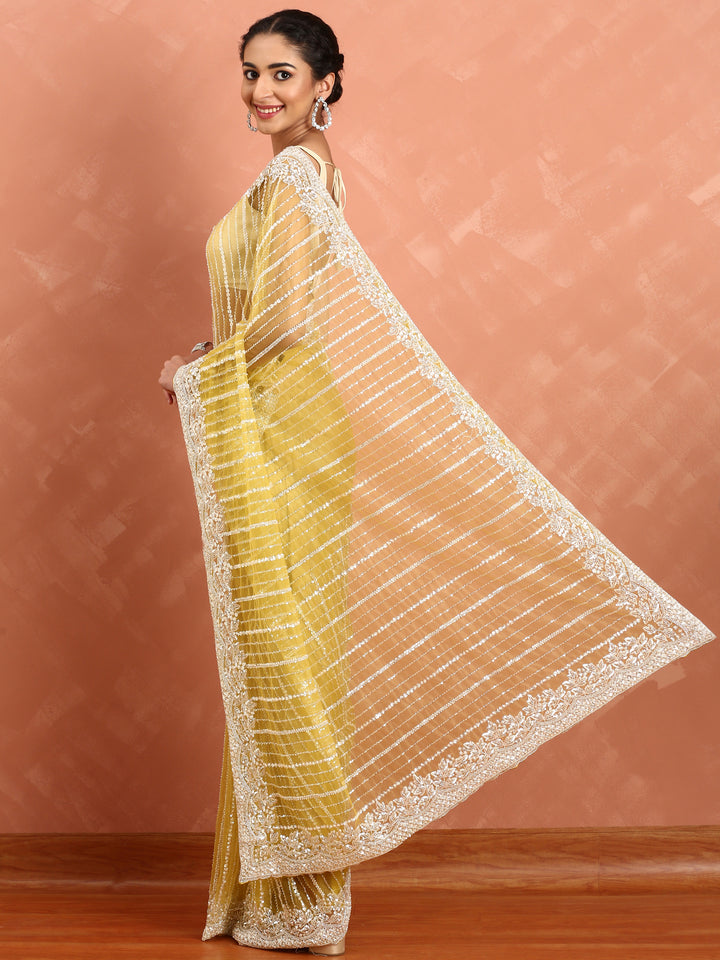 Lime yellow net saree with cut Dana hand embroidery